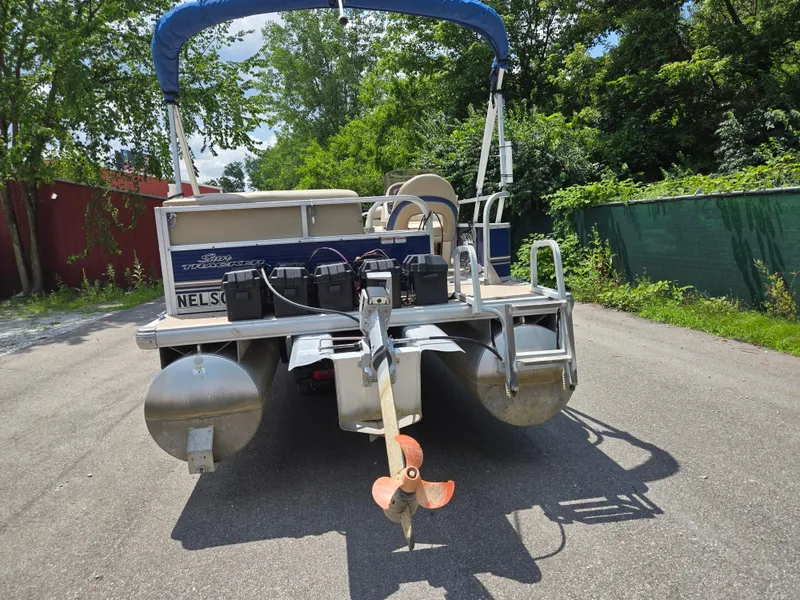 Slide: The Image of 2013 Sun Tracker Party Barge 18 DLX pontoon boat with canopy, parked on a sunny day. - 2
