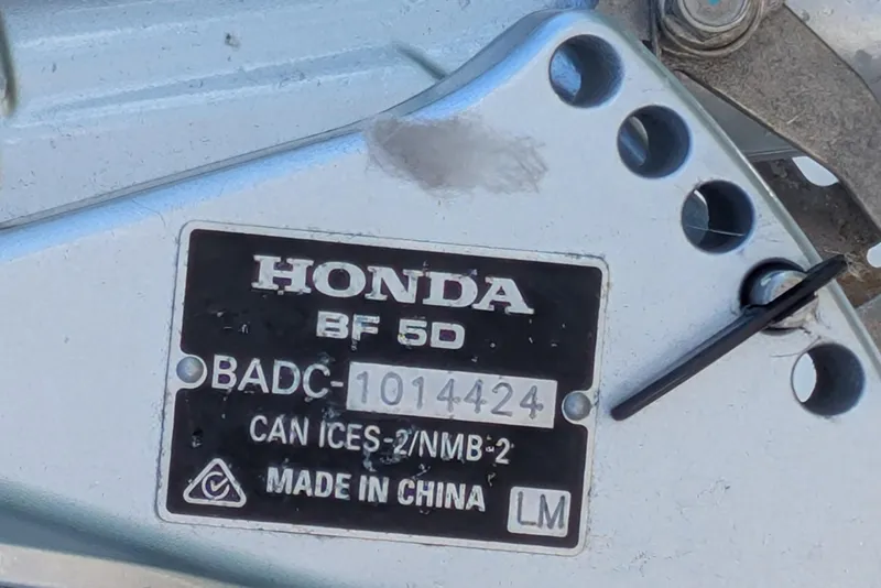 Slide: The Image of Close-up of a Honda BF 5D engine label, model BADC-1014424, made in China. - 10