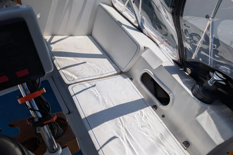 Slide: The Image of Interior of a 1995 Newport 326 boat, featuring white seating. - 13