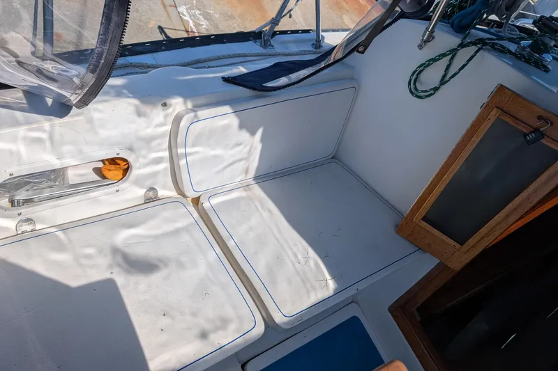 Slide: The Image of Port side Interior of a 1995 Newport 326 sailboat cockpit with seating and storage. - 15