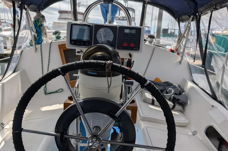 Slide: The Image of Cockpit of a 1995 Newport 326 sailboat with steering wheel and navigation instruments. - 18