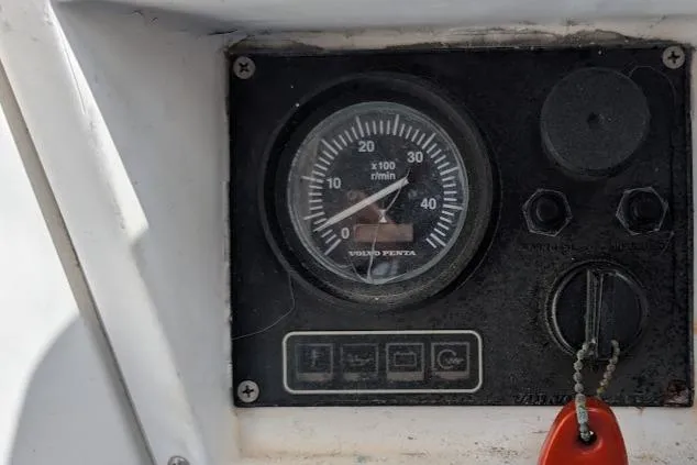 Slide: The Image of Close-up of a 1995 Newport 326 boat dashboard with a Volvo Penta tachometer. - 20