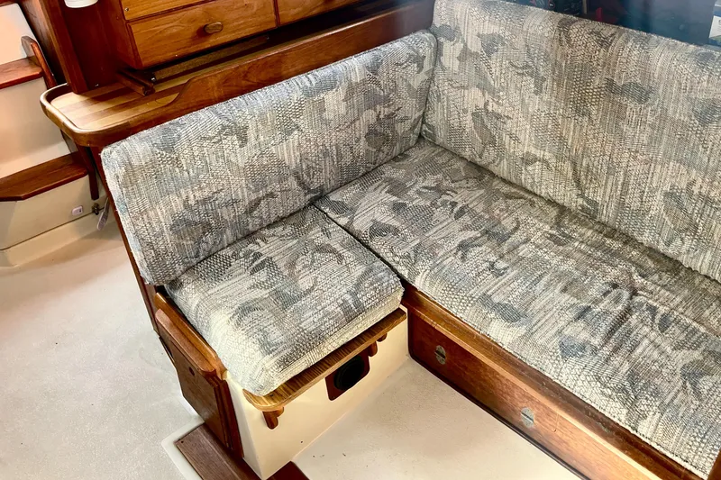 Slide: The Image of Interior of a 1995 Newport 326 boat with patterned seating and wooden accents. - 26