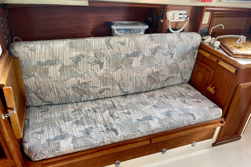 Slide: The Image of 1995 Newport 326 boat interior with patterned sofa and wooden cabinetry. - 27