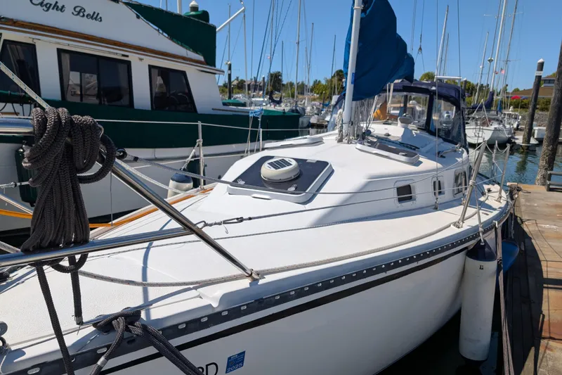 Slide: The Image of Sailboat Newport 326, 1995 model, docked in marina with clear blue sky. - 3