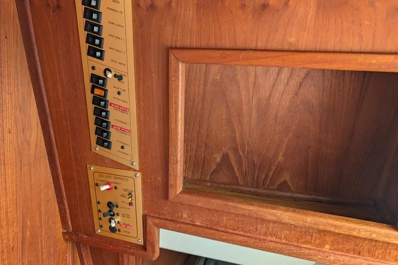 Slide: The Image of Wooden interior panel with electrical switches on a 1995 Newport 326 boat. - 31