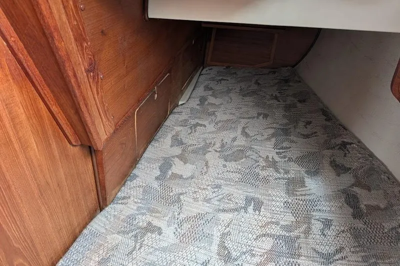 Slide: The Image of Interior of a 1995 Newport 326 with patterned flooring and wooden paneling. - 33