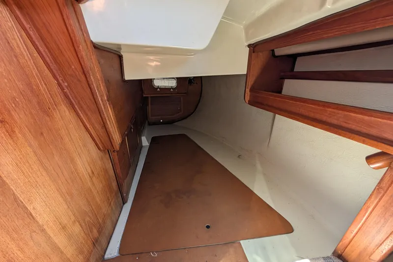 Slide: The Image of Aft port berth of a 1995 Newport 326 sailboat with wooden finishes. - 34