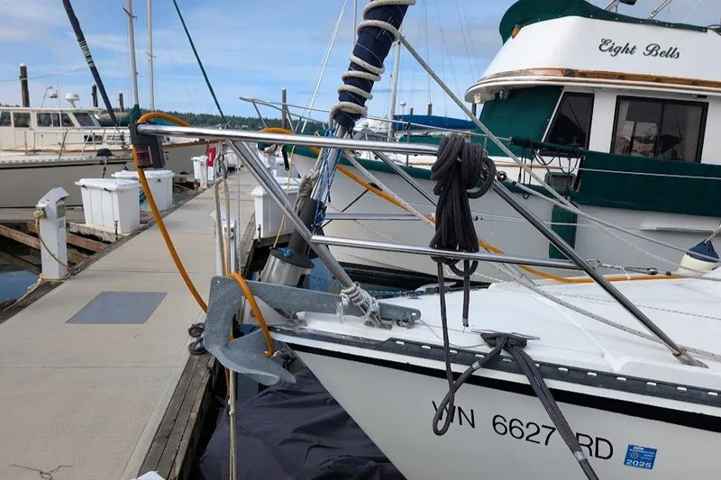 Slide: The Image of Sailboat Newport 326, 1995 model, docked at marina with visible anchor and ropes. - 5