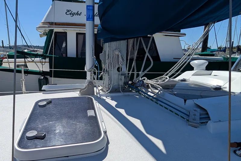 Slide: The Image of Sailboat deck with rigging, Newport 326 model, 1995, docked near another boat. - 6