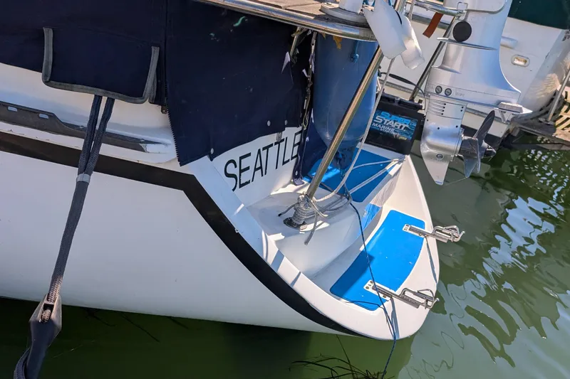 Slide: The Image of Sailboat stern with dinghy davits, Newport 326 model, docked in water. - 8