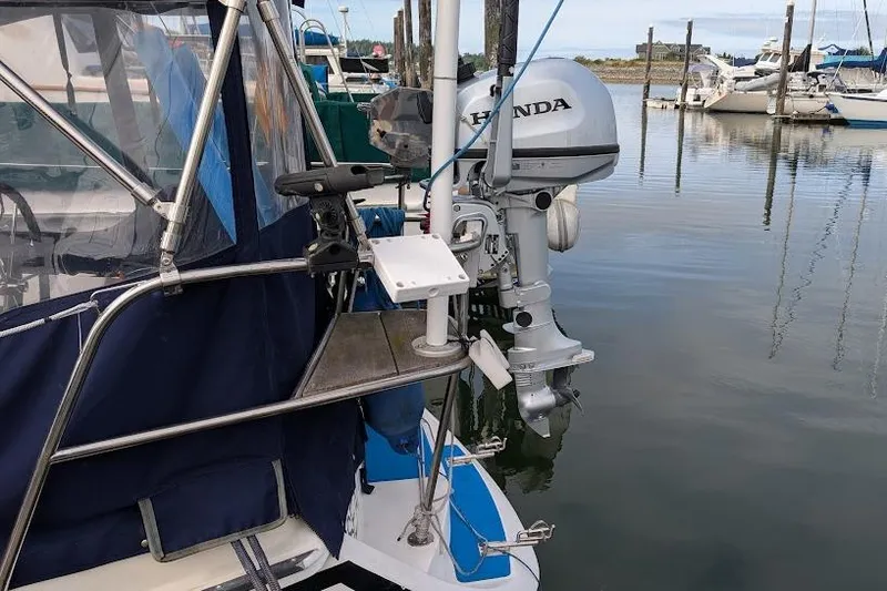 Slide: The Image of Newport 326 boat with Honda outboard motor docked at marina, 1995 model. - 9