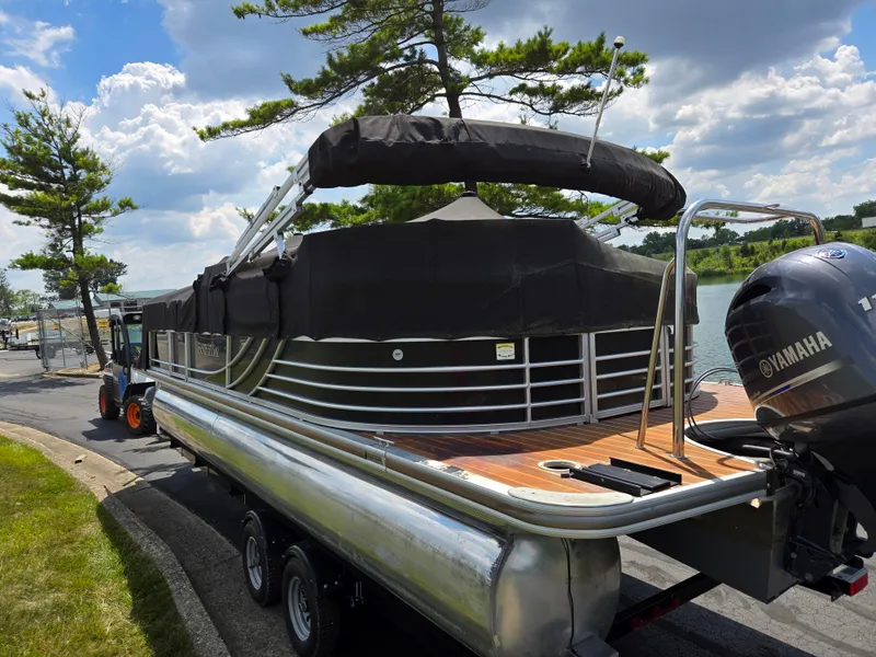 Slide: The Image of 2014 South Bay 522 E pontoon boat with Yamaha motor, parked near a lake under cloudy skies. - 10