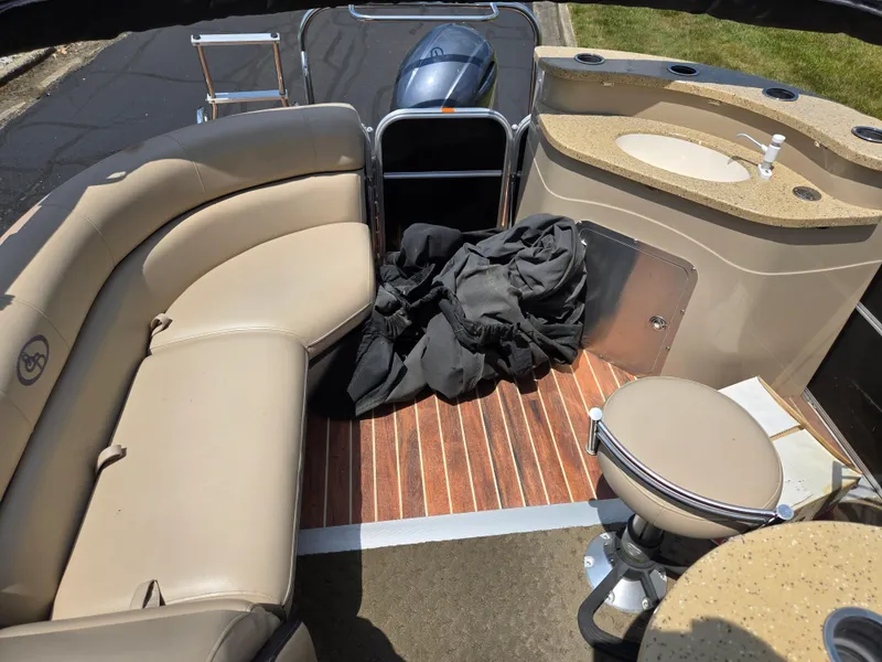 Slide: The Image of Interior of a 2014 South Bay 522 E pontoon boat with seating and a small sink. - 16