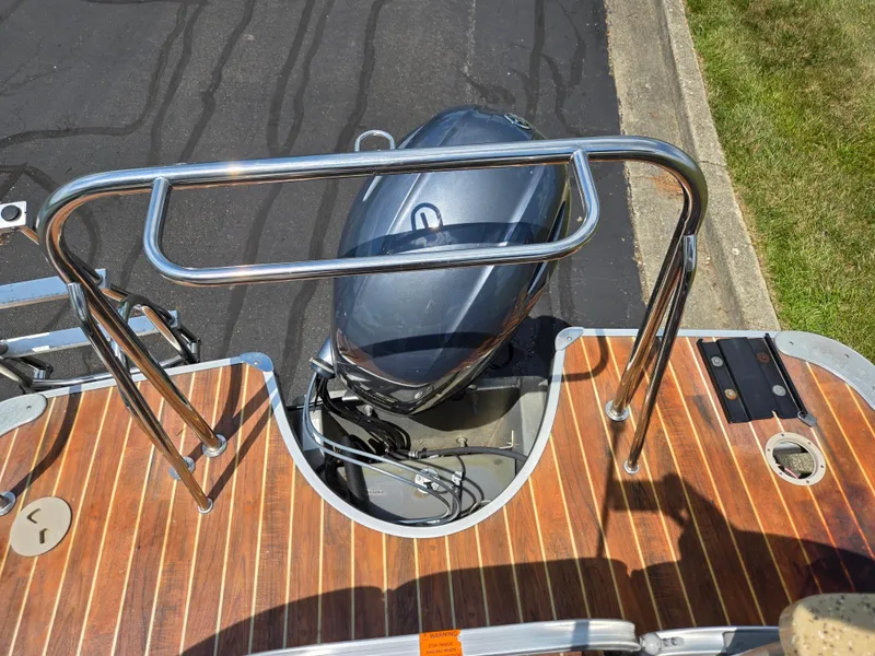 Slide: The Image of 2014 South Bay 522 E boat with wooden deck and outboard motor. - 18