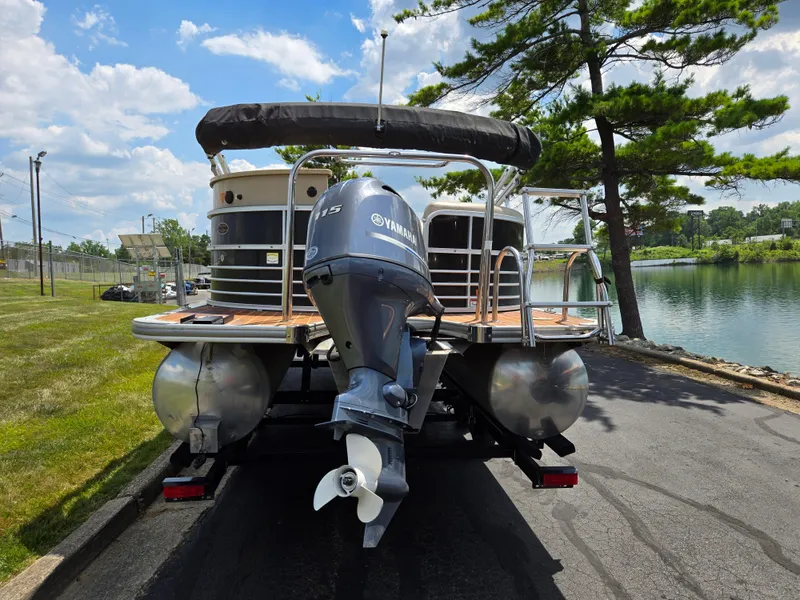 Slide: The Image of 2014 South Bay 522 E pontoon boat with Yamaha motor by a lake. - 2
