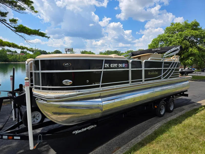 Slide: The Image of 2014 South Bay 522 E pontoon boat on trailer by a lake under a blue sky. - 8