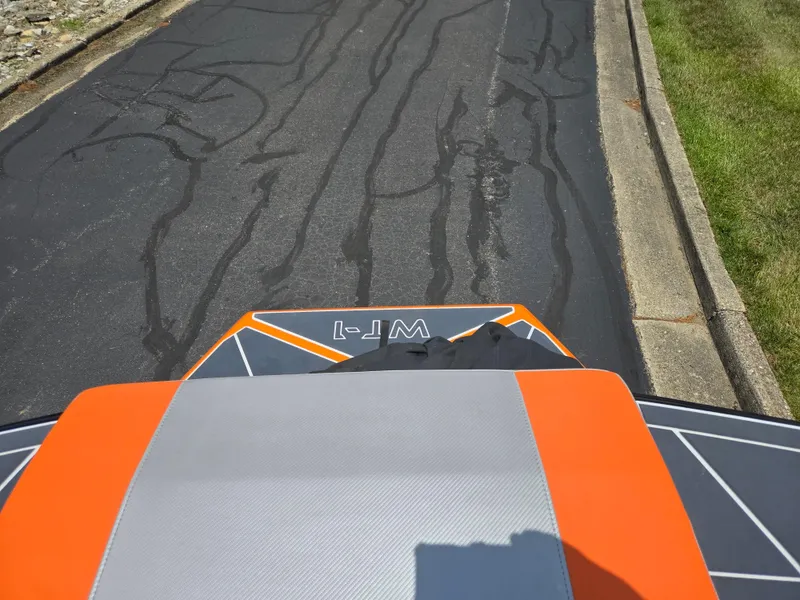 Slide: The Image of 2016 Heyday WT-1 boat on a paved road, showcasing its vibrant orange and gray design. - 19