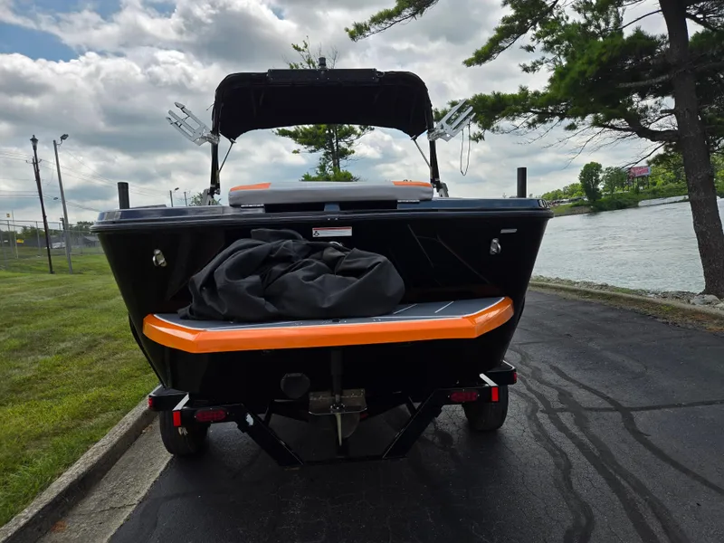 Slide: The Image of 2016 Heyday WT-1 boat on trailer by riverside, under cloudy sky. - 2