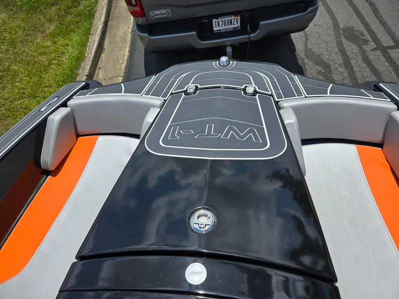 Slide: The Image of 2016 Heyday WT-1 boat interior with orange and gray seating, parked on a trailer. - 12