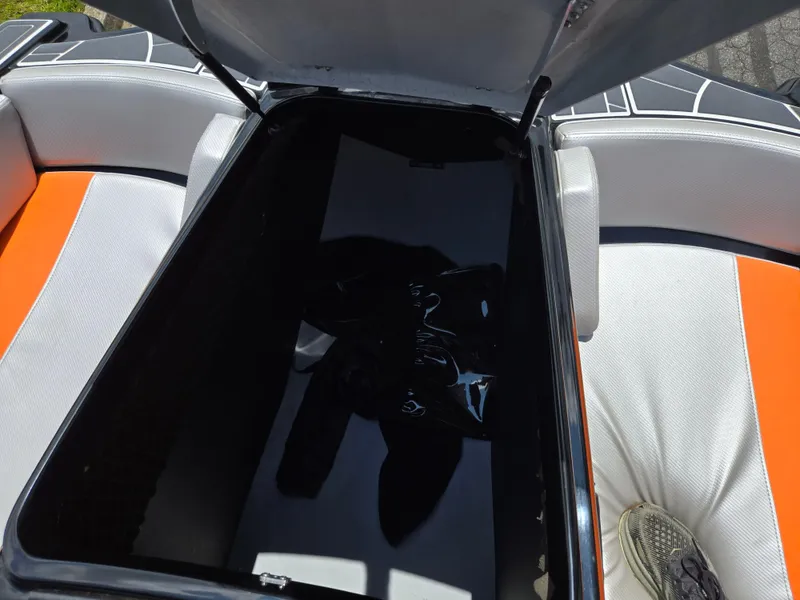 Slide: The Image of Open storage compartment in 2016 Heyday WT-1 boat with orange and white seating. - 13