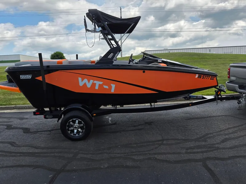 Slide: The Image of 2016 Heyday WT-1 boat in orange and black on a trailer, parked outdoors. - 4