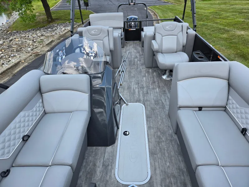 Slide: The Image of 2022 Crest Classic DLX 220 pontoon boat interior with gray seating and modern design. - 12