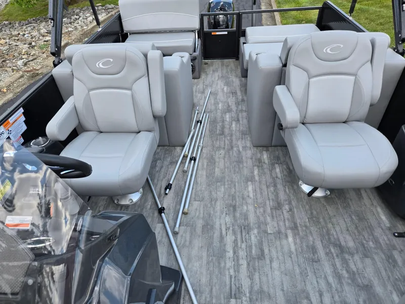 Slide: The Image of 2022 Crest Classic DLX 220 boat interior with gray seating and steering console. - 13