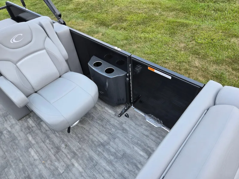 Slide: The Image of 2022 Crest Classic DLX 220 boat interior with gray seating and cup holders. - 14