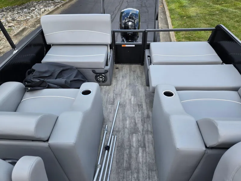 Slide: The Image of 2022 Crest Classic DLX 220 pontoon boat interior with gray seating and cup holders. - 15
