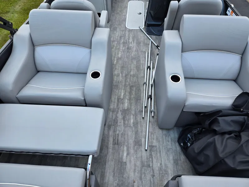 Slide: The Image of 2022 Crest Classic DLX 220 boat interior with gray seating and cup holders. - 17