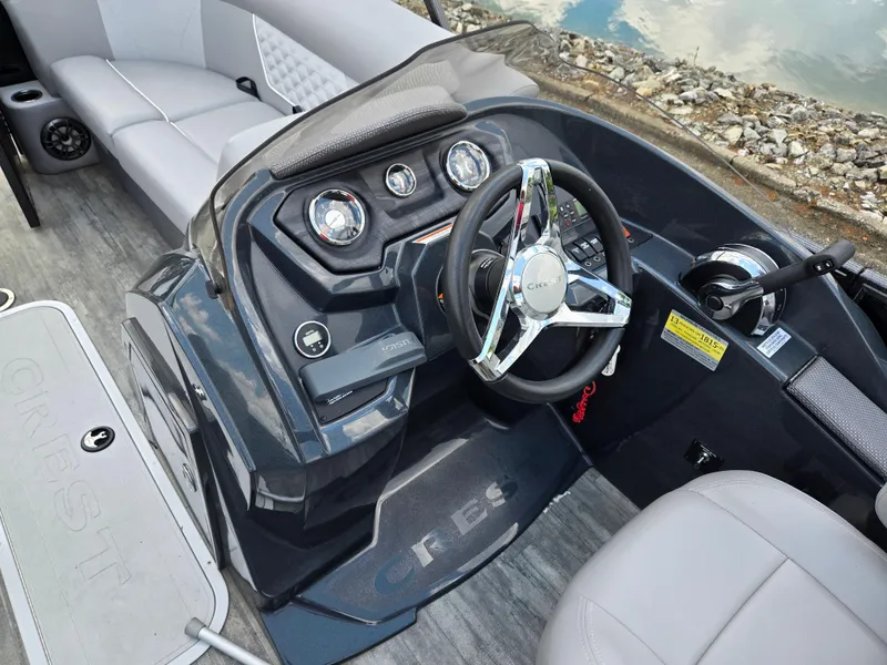 Slide: The Image of 2022 Crest Classic DLX 220 boat interior with steering wheel and seating. - 20