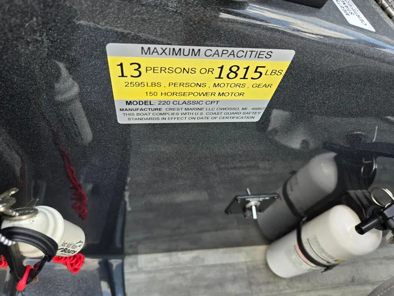 Slide: The Image of Capacity label on 2022 Crest Classic DLX 220 boat, showing limits and safety compliance. - 21
