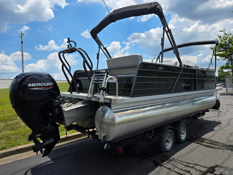 Slide: The Image of 2022 Crest Classic DLX 220 pontoon boat with Mercury engine on trailer. - 3
