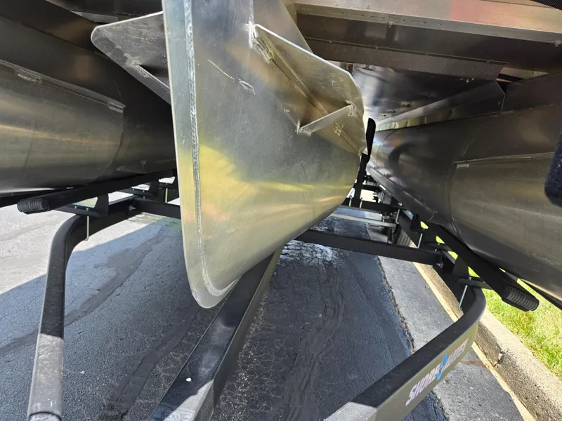 Slide: The Image of Underneath view of a 2022 Crest Classic DLX 220 pontoon boat on a trailer. - 8