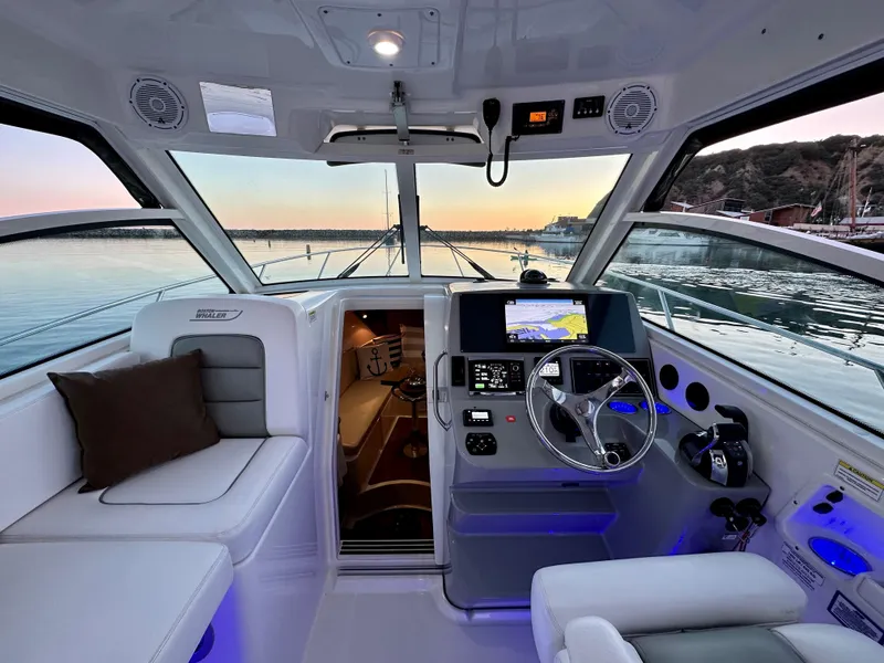 Slide: The Image of Interior of a 2014 Boston Whaler 315 Conquest boat with modern navigation equipment. - 10