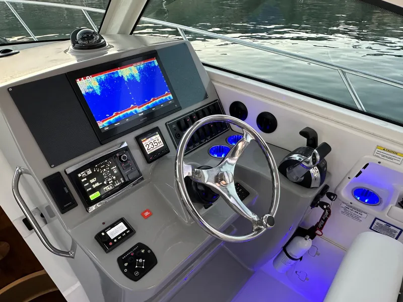 Slide: The Image of Helm of 2014 Boston Whaler 315 Conquest with advanced navigation and control systems. - 26