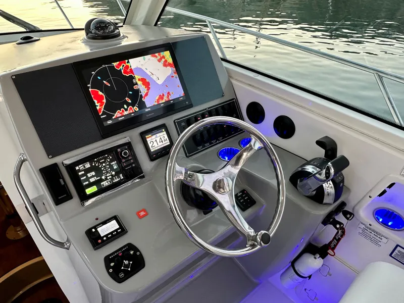 Slide: The Image of Control panel of a 2014 Boston Whaler 315 Conquest boat with navigation screens. - 27