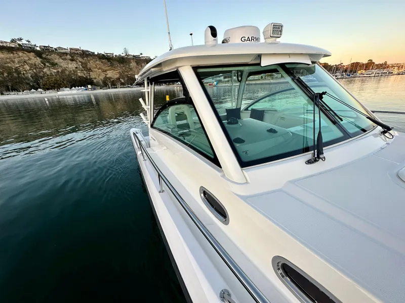 Slide: The Image of 2014 Boston Whaler 315 Conquest boat docked in calm waters at sunset. - 33