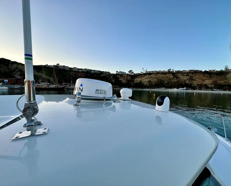 Slide: The Image of 2014 Boston Whaler 315 Conquest boat with radar equipment, docked in a scenic harbor. - 35