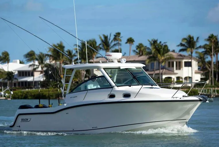 Slide: The Image of Manufacturer Provided Image: 2014 Boston Whaler 315 Conquest cruising on water near luxury homes. - 38