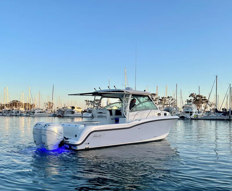Slide: The Image of 2014 Boston Whaler 315 Conquest boat in marina, calm water, clear sky. - 4