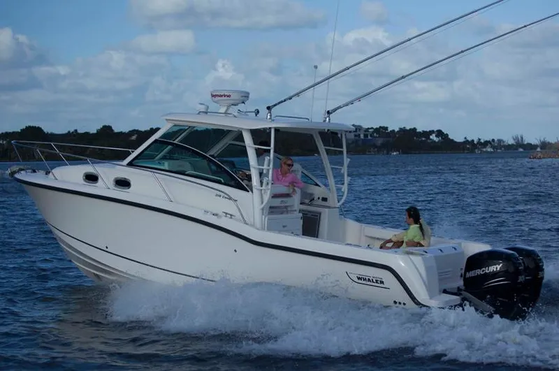 Slide: The Image of Manufacturer Provided Image: 2014 Boston Whaler 315 Conquest boat cruising on water. - 40