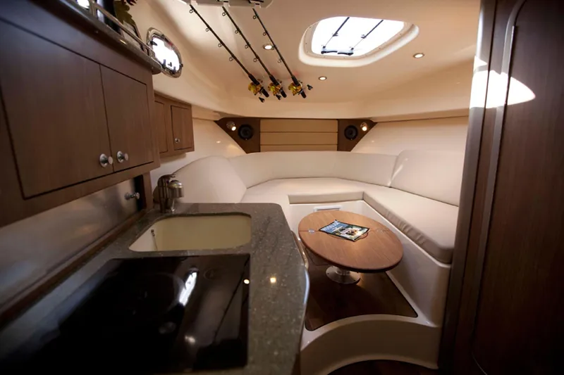 Slide: The Image of Manufacturer Provided Image: 2014 Boston Whaler 315 Conquest cabin interior with kitchenette and seating area. - 46