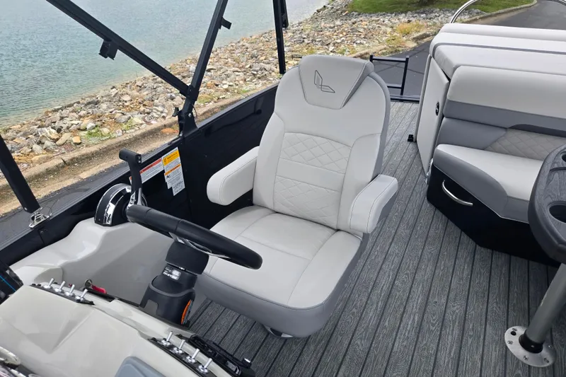 Slide: The Image of Captain's chair on 2022 Lowe SS 230 CL boat, near water, with modern interior design. - 15