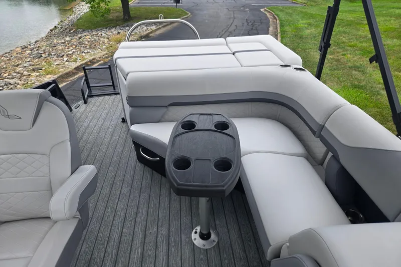 Slide: The Image of 2022 Lowe SS 230 CL pontoon boat interior with gray seating and cup holders. - 16