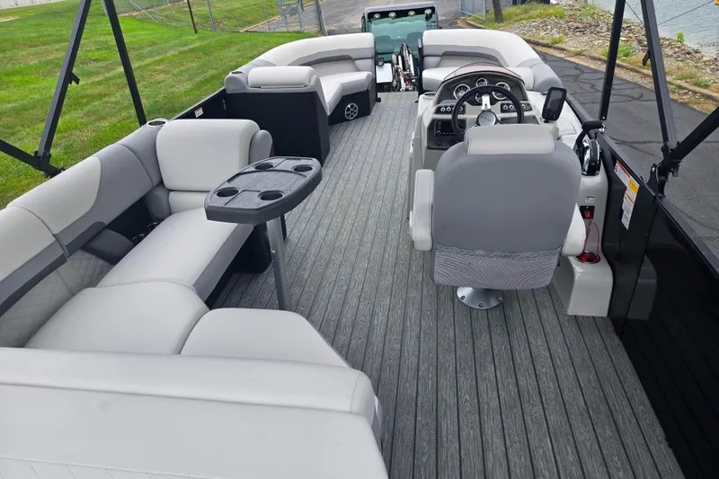 Slide: The Image of Interior of 2022 Lowe SS 230 CL pontoon boat with plush seating and modern controls. - 21
