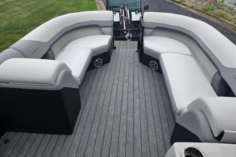 Slide: The Image of 2022 Lowe SS 230 CL boat interior with gray seating and flooring, showcasing spacious and modern design. - 24