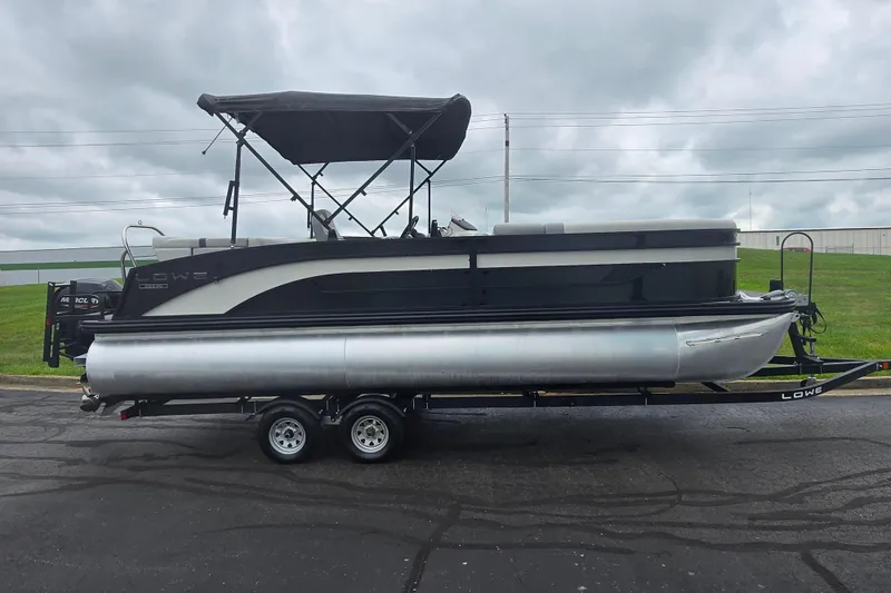 Slide: The Image of 2022 Lowe SS 230 CL pontoon boat on trailer, overcast sky background. - 5