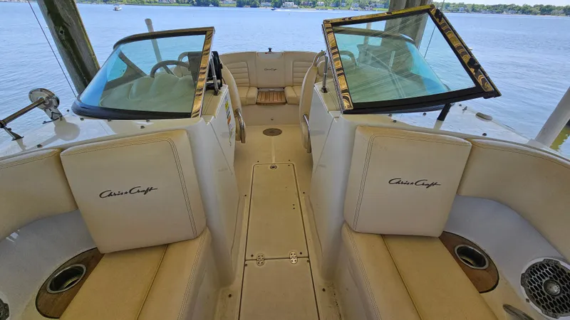 Slide: The Image of 2013 Chris-Craft Launch 22 boat interior with beige seating and dual windshields. - 13